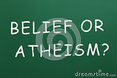 Phrase Belief Or Atheism? written on green chalkboard Stock Photo