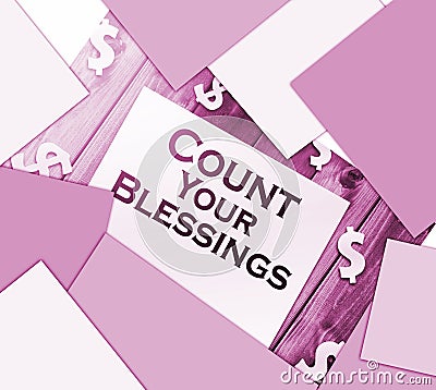 The phrase Count Your Blessings typed on a piece of paper and paper dollar signs around. Career concept Stock Photo