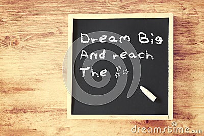 The phrase dream big written on chalkboard Stock Photo