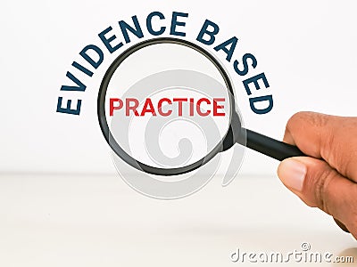 Phrase evidence based practice with hand hold magnifying glass. Stock Photo