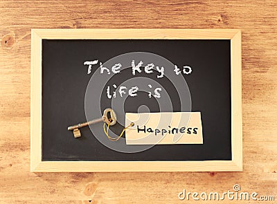 The phrase the key to life is happiness written on blackboard Stock Photo