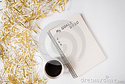 Phrase My Goals 2020 in a notebook. Mug of coffee on the table, top view Stock Photo