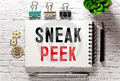 The phrase Sneak Peek appearing behind torn paper Stock Photo