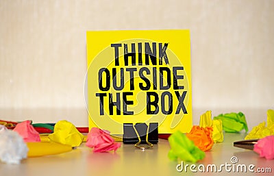 The phrase Think Outside the Box written in white chalk on a blackboard Stock Photo