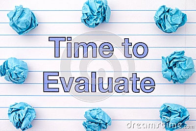 The phrase Time To Evaluate written on a lined notebook sheet with some crumpled paper balls around it Stock Photo