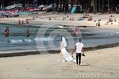 Phuket, Thailand - December 4, 2019: A wedding ceremony at Kamala Beach, Phuket. Beautiful bride at the seaside. Photographer at Editorial Stock Photo