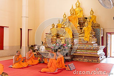 Phuket, Thailand, 04/19/2019 - Group of buddhist monks praying together at the Chalong Temple Editorial Stock Photo