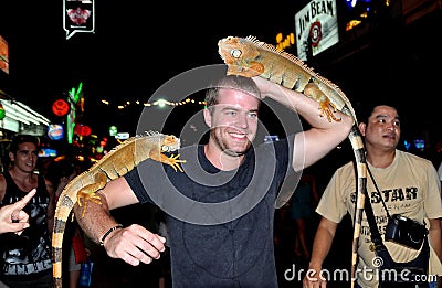 Phuket, Thailand: Man Posing with Lizards Editorial Stock Photo