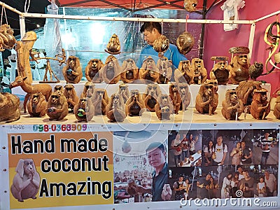 Handmade monkey sculptures out of coconut for sale at dragon night market in Phuket, Thailand Editorial Stock Photo