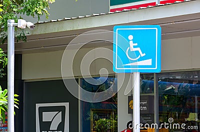 Phuket, Thailand - September 14, 2017 : blue wheelchair ramp sign mark for the disabled and cctv camera in front of 7-Eleven shop Editorial Stock Photo