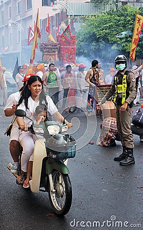 Phuket Town / Thailand - October 7, 2019: Phuket Vegetarian Festival or Nine Emperor Gods Festival parade with woman and child on Editorial Stock Photo