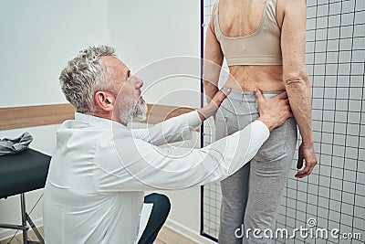 Physiatrist examining a lumbar spine of a female patient Stock Photo
