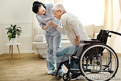 Nice aged man trying to get up Stock Photo