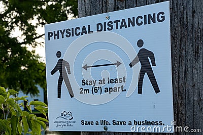 Physical Distancing sign in Ontario town Editorial Stock Photo