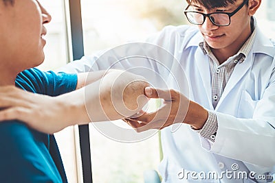 Physical Doctor consulting with patient About elbow muscule pain problems Physical therapy diagnosing concept Stock Photo