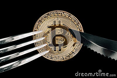 Physical Golden Crytocurrency Coin under fork and knive. Stock Photo