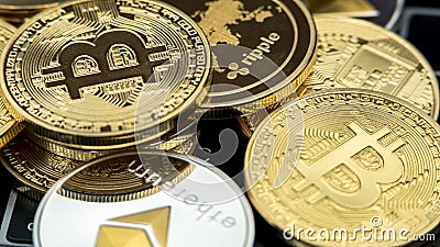 Physical metal currency on notebook computer keyboard. New Cryptocurrency Stock Photo