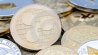 Physical metal golden Ripplecoin currency over others coins. Ripple coin Editorial Stock Photo