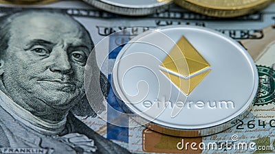 Physical metal silver Ethereum currency over 100 american dollar bill Editorial Stock Photo