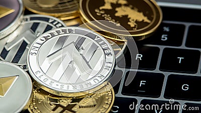 Physical metal silver Litecoin currency on notebook computer keyboard LTC Stock Photo