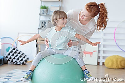 Physical therapist assisting little boy Stock Photo
