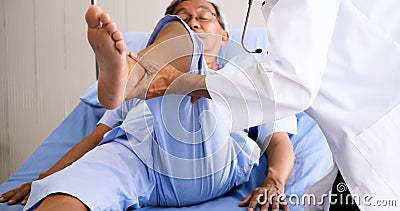 Physical therapist doing physical therapy for senior patient at hospital room Stock Photo