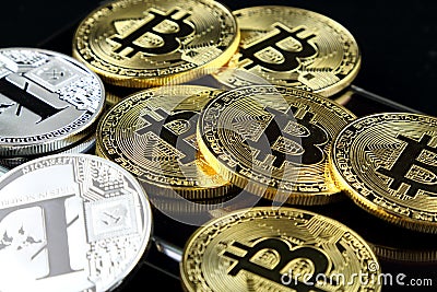 Physical version of Bitcoin and Litecoin, new virtual money. Conceptual image for worldwide cryptocurrency and digital payment sys Stock Photo