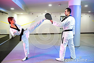 Physically challenged young woman in taekwondo practicing a high kick Stock Photo