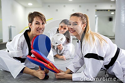 Physically disabled martial art combat fighter and her friend holding a kick pad target Stock Photo