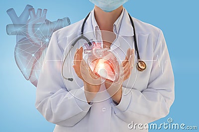 Physician cardiologist shows a human heart . Stock Photo