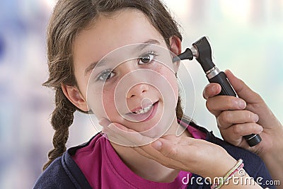 ENT physician checking patient`s ear using otoscope Stock Photo