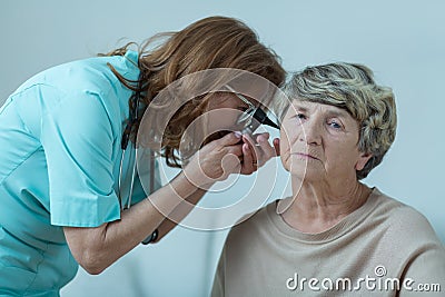 Physician examining elderly woman Stock Photo
