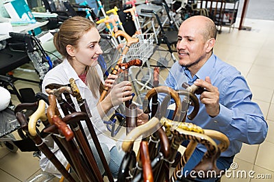 Physician offering cane to customer Stock Photo