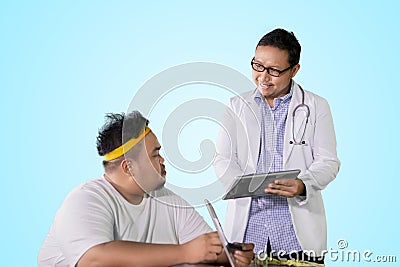 Physician shows medical results to his fat patient Stock Photo