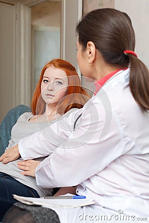 Physician touching stomach of teenager patient Stock Photo