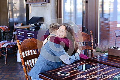 Physicist with smartwatch on hand in cafe with colleague taking Stock Photo