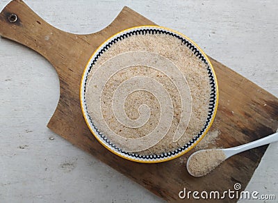 Physillium husk powder in bowl for healthy digestion Stock Photo