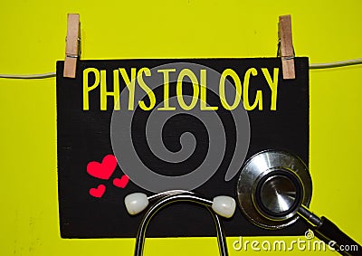 PHYSIOLOGY on top of yellow background Stock Photo