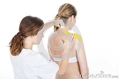 Physiotherapist applying tapes Stock Photo