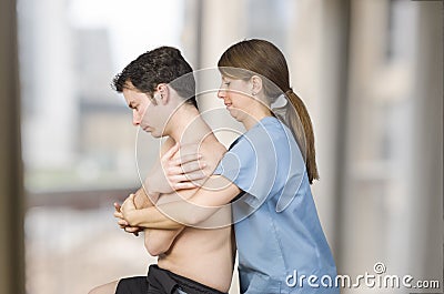 Physiotherapist, chiropractor is doing a global dorsal manipulation for a male patient Stock Photo