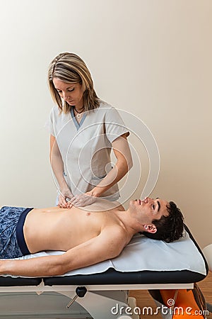 physiotherapist does session to man. dorsal manipulation, thrust, lumbar roll Stock Photo