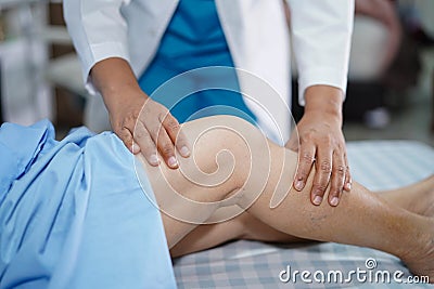 Physiotherapist doing physical therapy in rehab with patient in nursing hospital ward Stock Photo