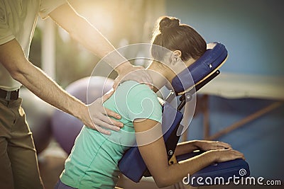 Physiotherapist giving back massage to a female patient Stock Photo