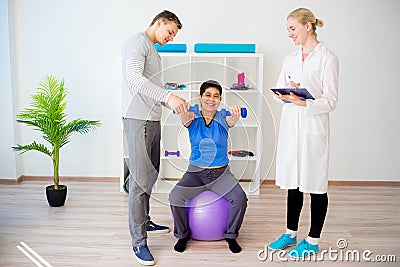 Physiotherapist helping a senior woman Stock Photo