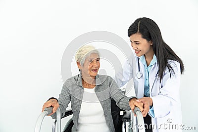 Physiotherapist Looking At Senior Patient Sitting In Wheelchair, doctor and patient on wheelchair Stock Photo