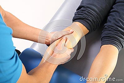Physiotherapist massaged patient's leg. Stock Photo