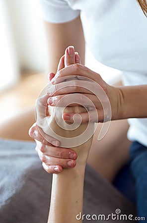 Physiotherapist pressing specific spots on female palm. Stock Photo