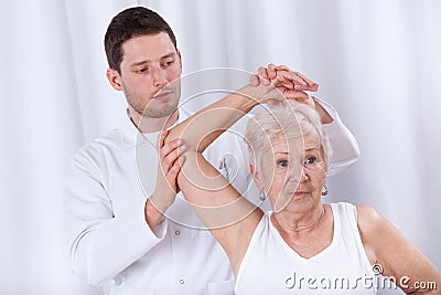 Physiotherapist rehabilitating elderly woman Stock Photo