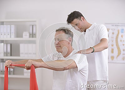 Physiotherapy: Senior man and physiotherapist Stock Photo