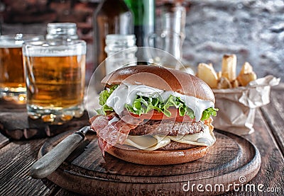 Piano burger with bacon and cutlet with cheese, tomato, greens. Stock Photo